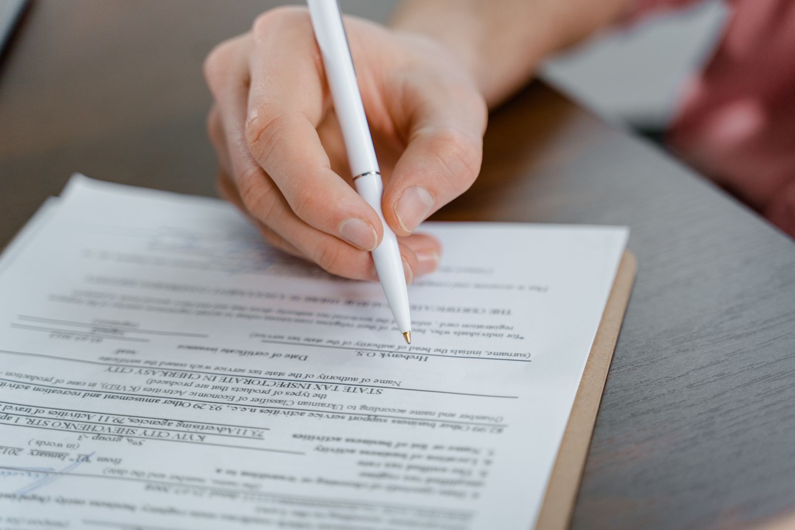 Refinance paperwork being signed at a table